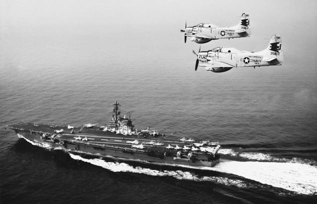 Two Douglas AD-5W Skyraiders fly over the USS Forrestal during operations with the Sixth Fleet in the Mediterranean Sea in 1960. (US Navy)